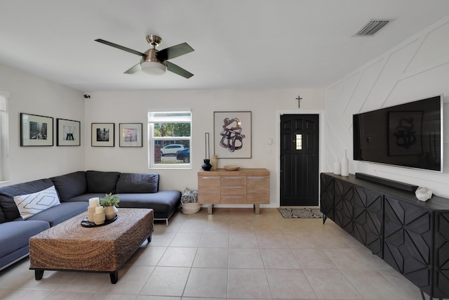 living room featuring light tile patterned floors and ceiling fan