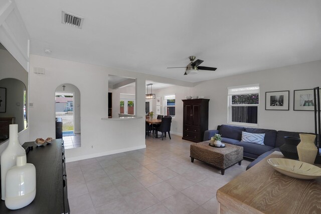 1305 NE 1st Ave, Fort Lauderdale, FL 33304 - living area with light tile patterned floors, ceiling fan, healthy amount of natural light, and arched walkways