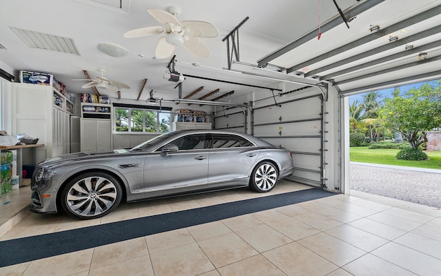 garage with a garage door opener and ceiling fan