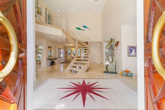 entrance foyer with tile patterned floors and a towering ceiling