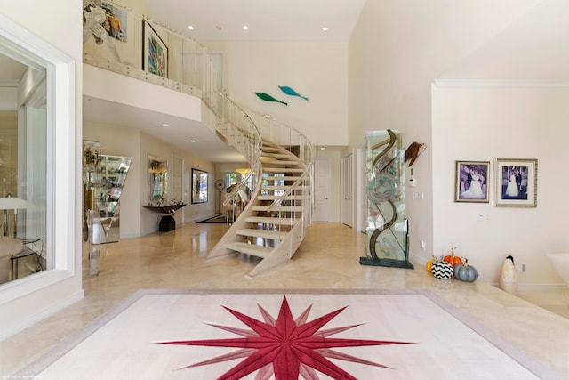 tiled foyer with a towering ceiling