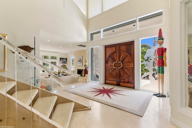 tiled entryway with a high ceiling