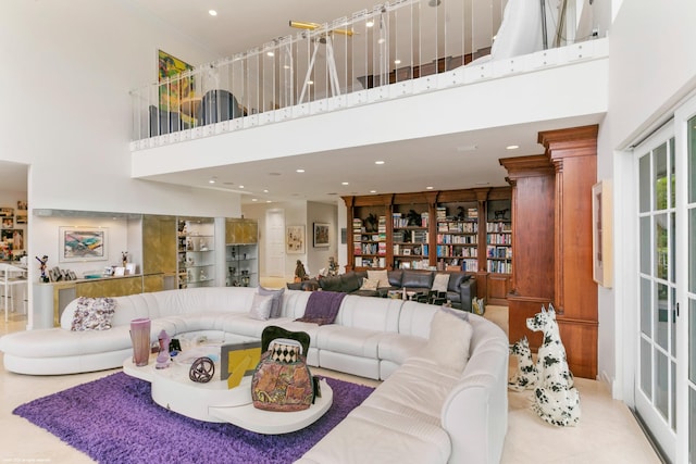 living room with light tile patterned floors and a high ceiling