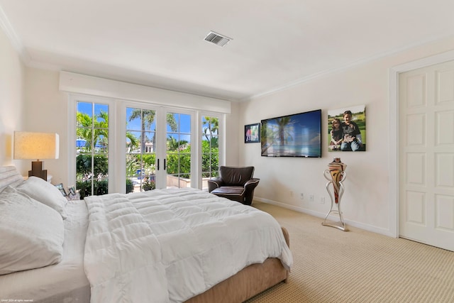 bedroom with crown molding, light colored carpet, and french doors