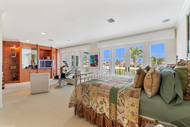 carpeted bedroom featuring access to outside, french doors, and ornamental molding