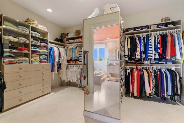 walk in closet with light tile patterned floors