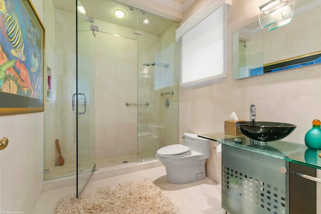 bathroom featuring vanity, tile walls, toilet, and tile patterned flooring