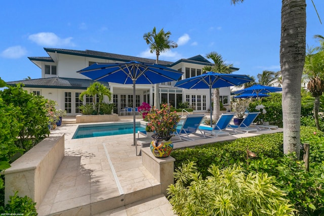 view of pool featuring french doors and a patio area