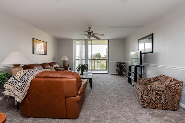 living room with ceiling fan, a wall of windows, and light carpet