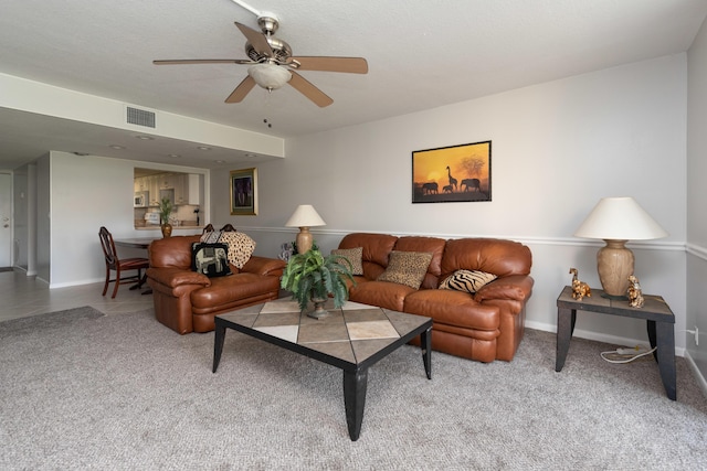 carpeted living room featuring a textured ceiling and ceiling fan