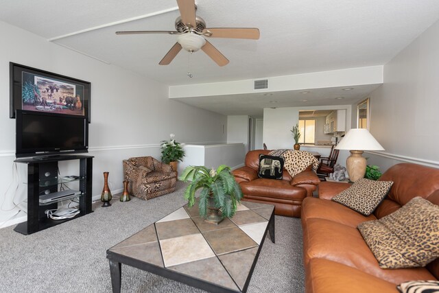 living room featuring carpet floors and ceiling fan