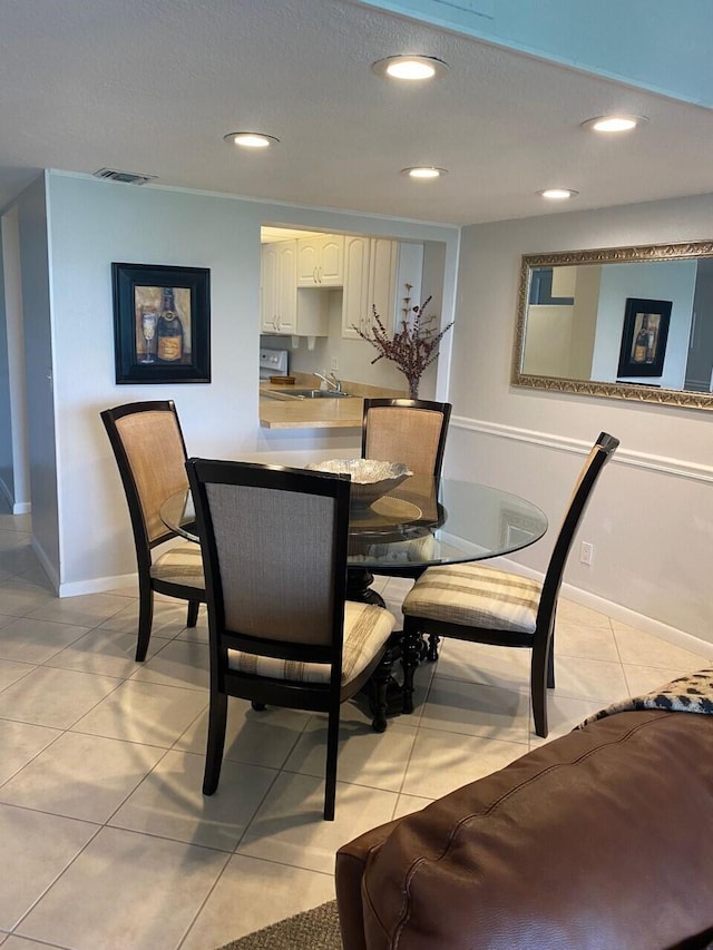 dining area with sink and light tile patterned floors