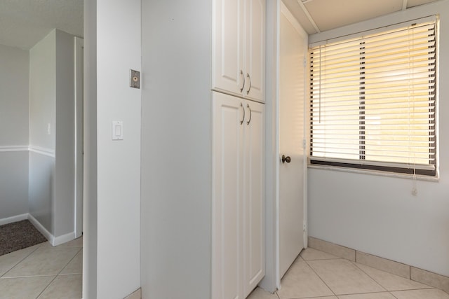 corridor featuring light tile patterned floors