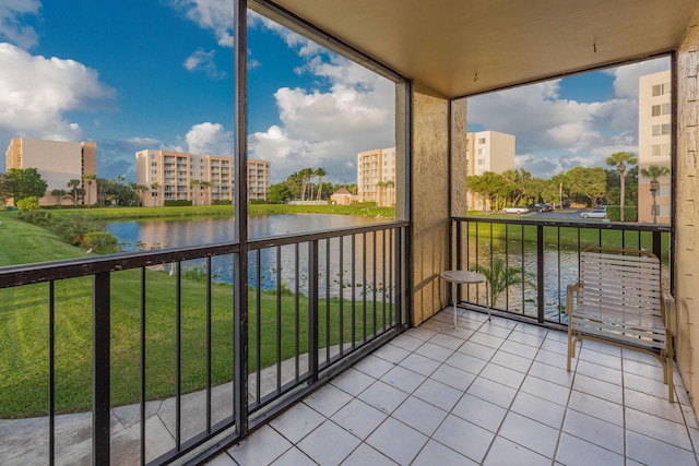 unfurnished sunroom featuring a water view