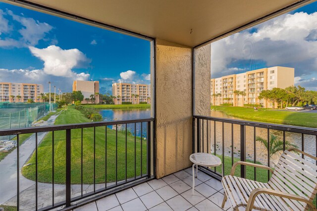 unfurnished sunroom featuring a water view