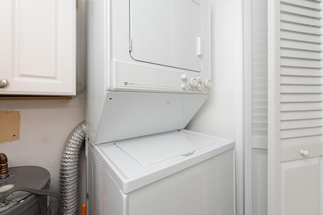 clothes washing area featuring stacked washing maching and dryer