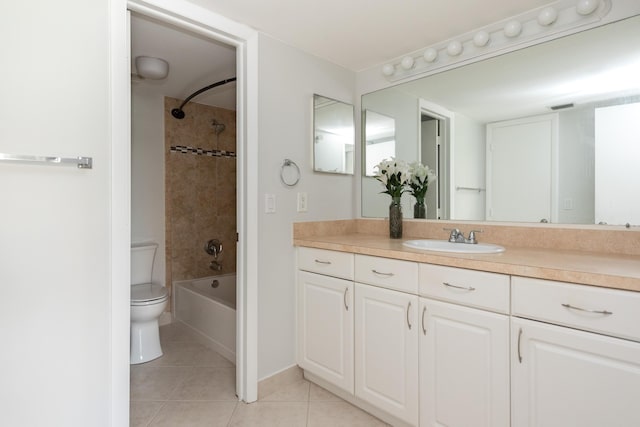 full bathroom with tile patterned flooring, vanity, toilet, and tiled shower / bath