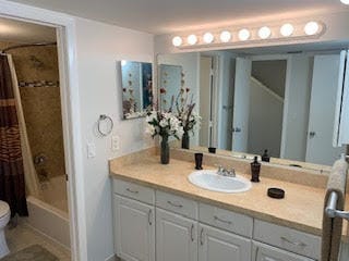 full bathroom with vanity, shower / bath combination with curtain, and toilet