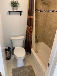 bathroom featuring tile patterned floors, toilet, and shower / bath combo