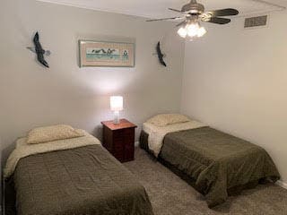 bedroom with ceiling fan and carpet