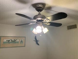 interior details featuring ceiling fan and a textured ceiling