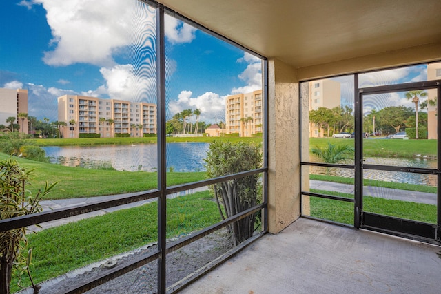 unfurnished sunroom with a water view