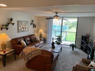 living room with carpet and ceiling fan