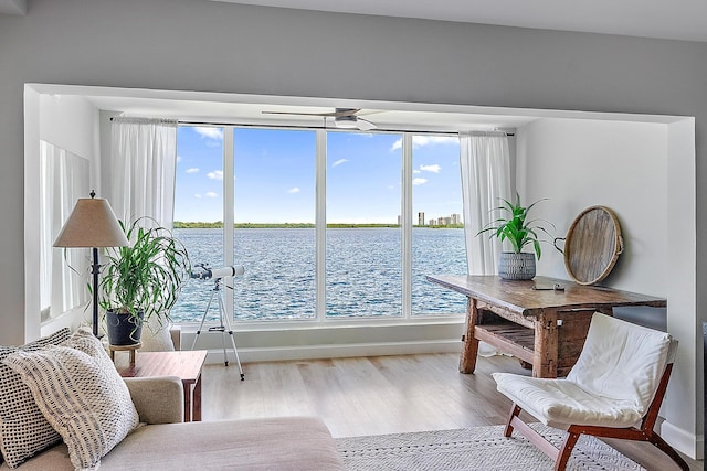 living area featuring a water view and wood-type flooring