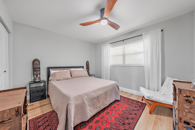 bedroom with light wood-type flooring, a closet, and ceiling fan