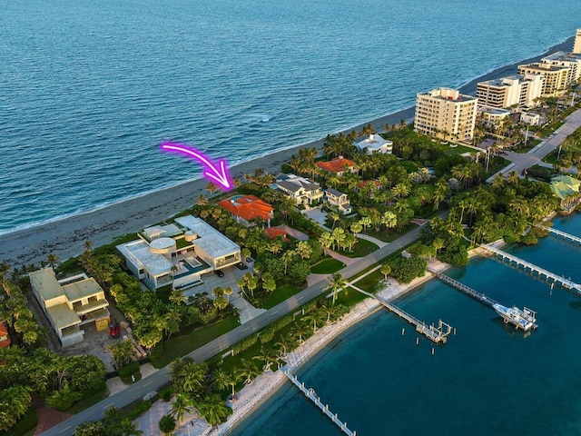 drone / aerial view featuring a view of the beach and a water view