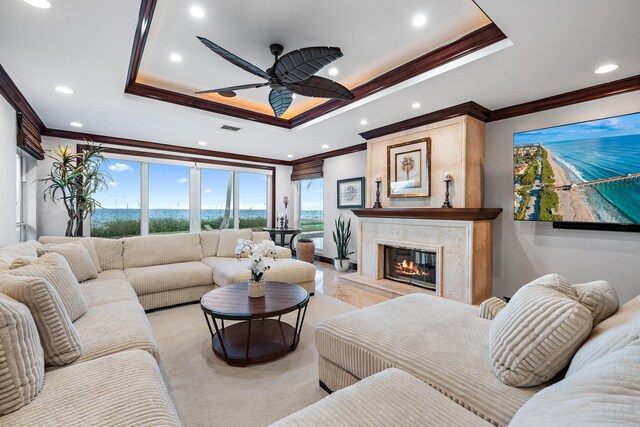 carpeted bedroom with ceiling fan, access to outside, ornamental molding, and a raised ceiling