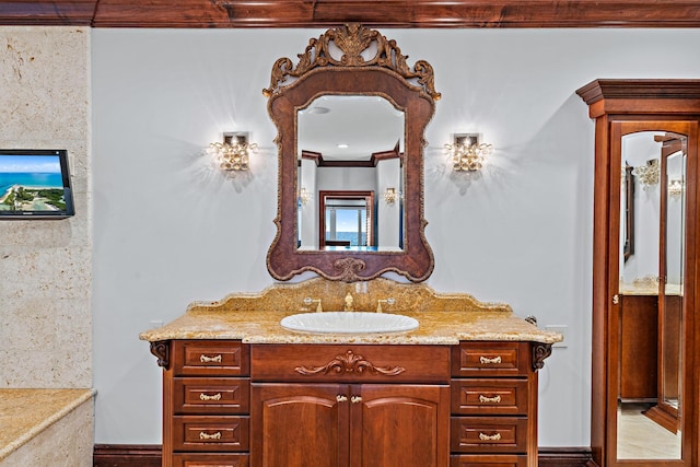 bathroom with crown molding and vanity