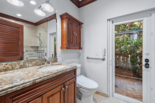 bathroom with toilet, a shower, crown molding, and vanity