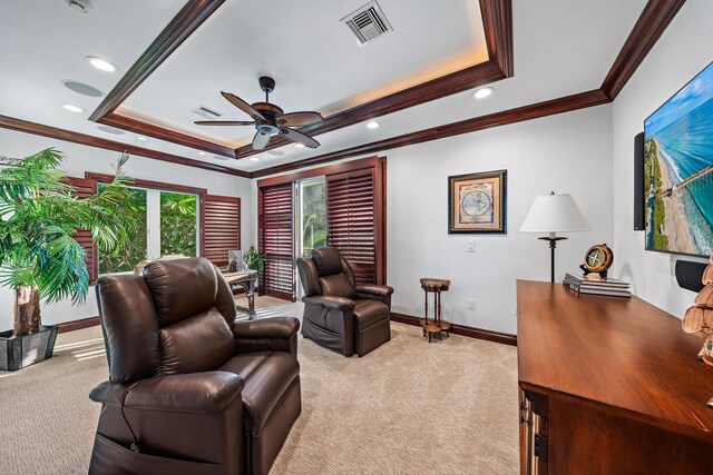 interior space featuring ceiling fan, a tray ceiling, and crown molding