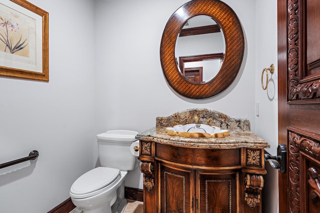 bathroom featuring toilet and vanity