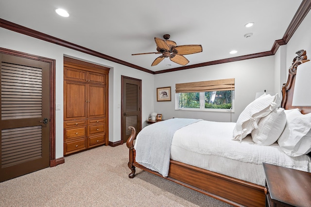 carpeted bedroom featuring ceiling fan, a closet, and crown molding