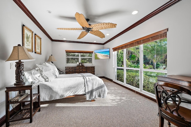 carpeted bedroom with ceiling fan, crown molding, and multiple windows