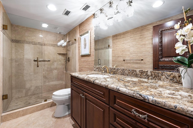 full bathroom featuring a stall shower, visible vents, vanity, and toilet