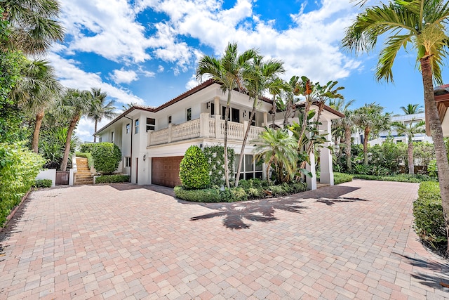 mediterranean / spanish-style home with a balcony and a garage