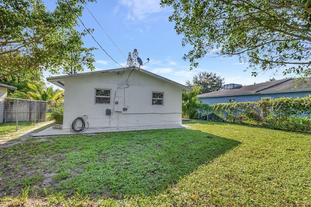 back of property featuring a yard