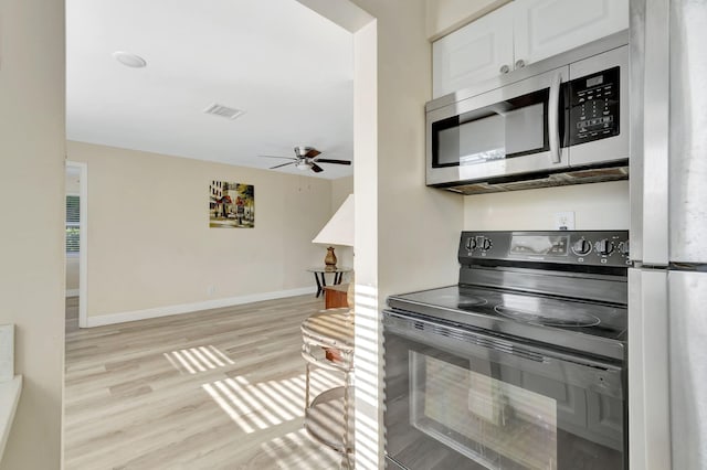 kitchen featuring light hardwood / wood-style floors, white cabinetry, ceiling fan, and stainless steel appliances