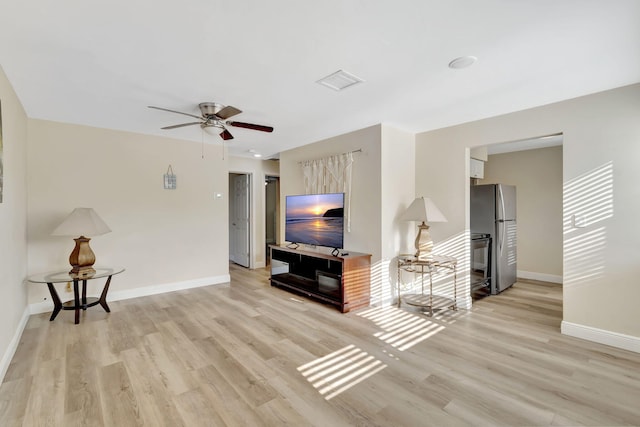 living room featuring light hardwood / wood-style floors and ceiling fan