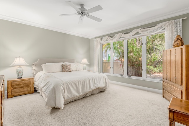 carpeted bedroom featuring ceiling fan, ornamental molding, and multiple windows