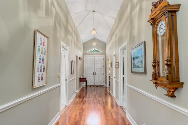 doorway to outside featuring hardwood / wood-style flooring and high vaulted ceiling