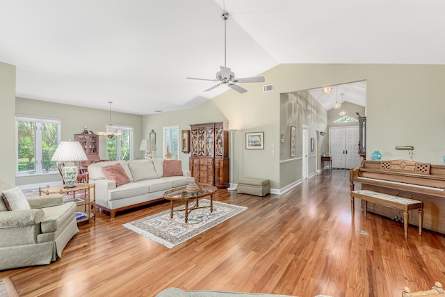 living room with ceiling fan, wood-type flooring, and lofted ceiling