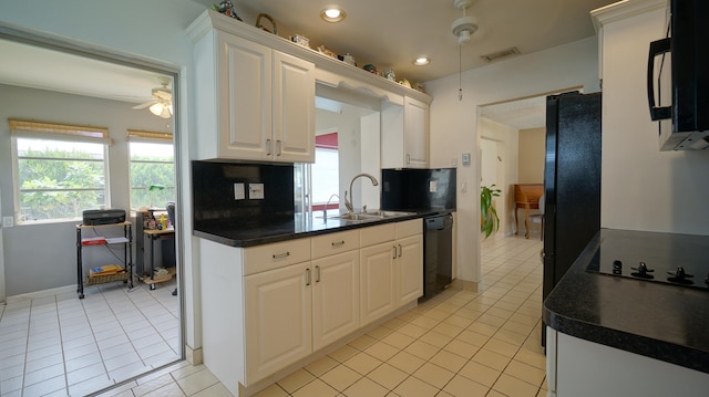 kitchen featuring white cabinets, light tile patterned floors, sink, and black appliances