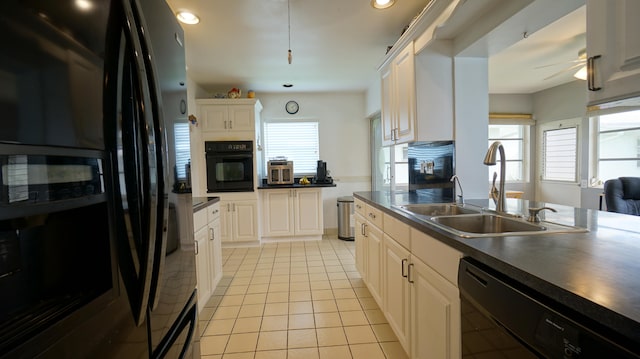 kitchen with sink, black appliances, light tile patterned floors, ceiling fan, and white cabinets