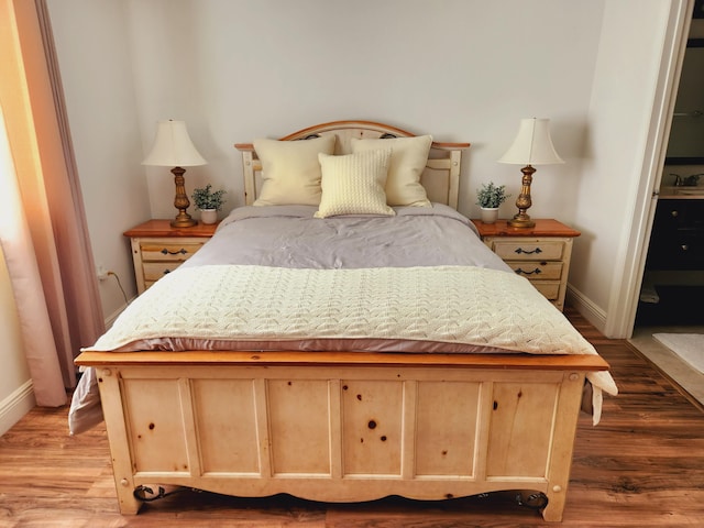 bedroom featuring light wood-type flooring and baseboards