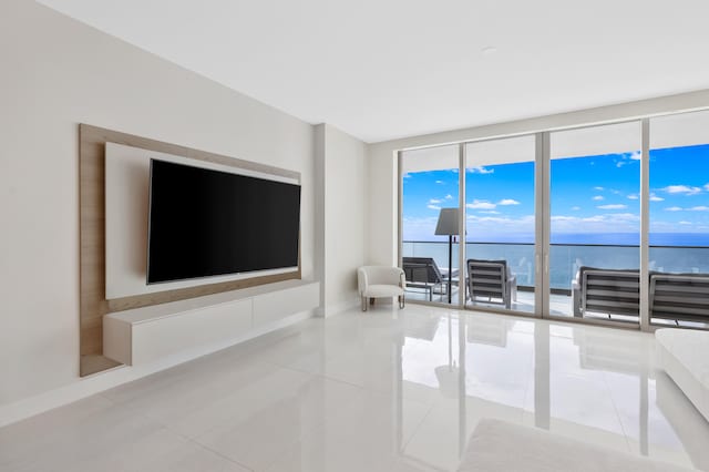 unfurnished living room with tile patterned flooring and floor to ceiling windows