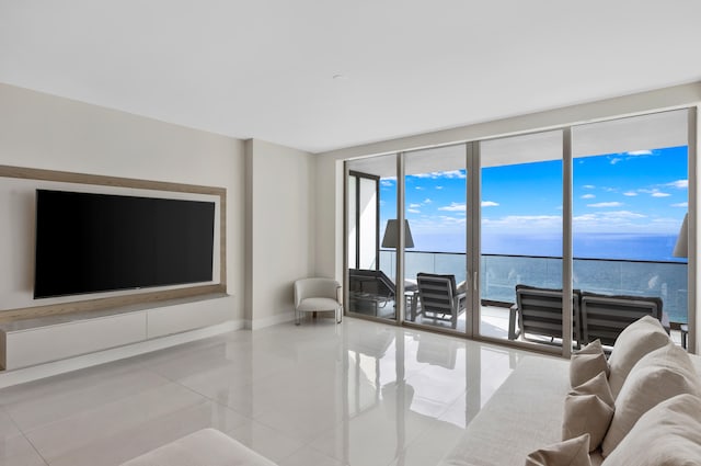 tiled living room with expansive windows and a water view